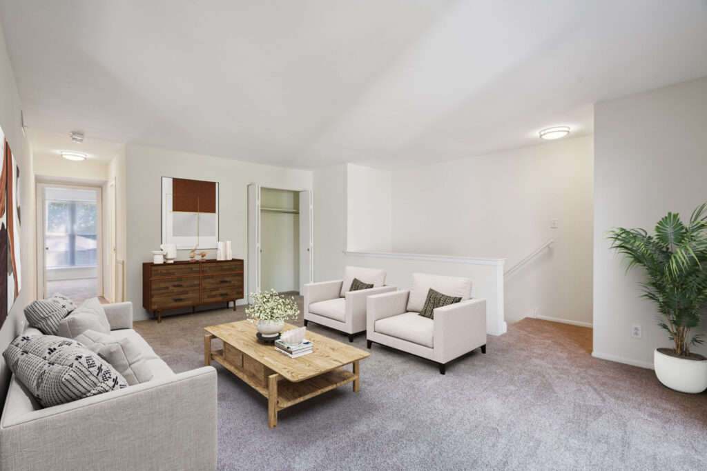 Spacious seating area with two chairs seated across from a couch at Meetinghouse Apartments and Townhomes