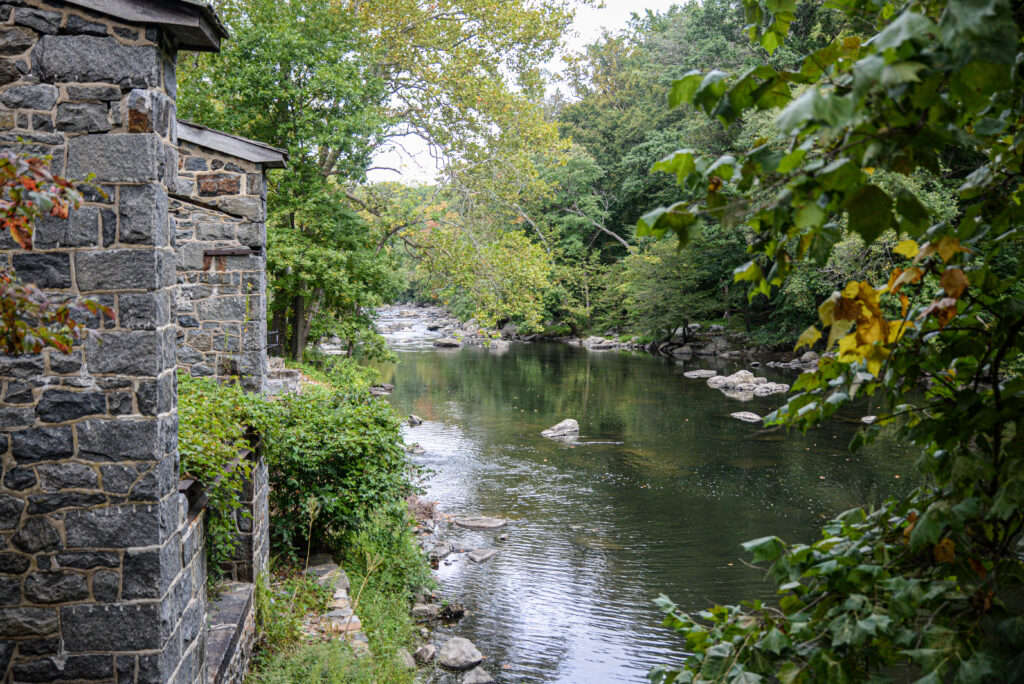 Photo of a river with a stone building in the foreground